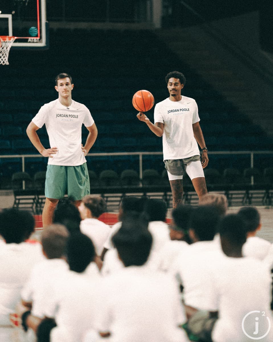 Joey Hewitt and Jordan Poole standing together at basketball camp